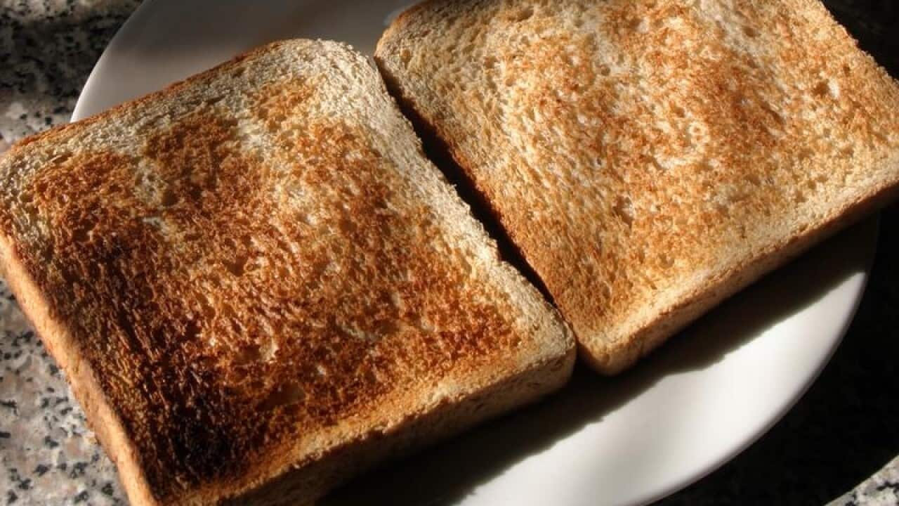 A breakfast containing a cup of coffee and two slices of toast.