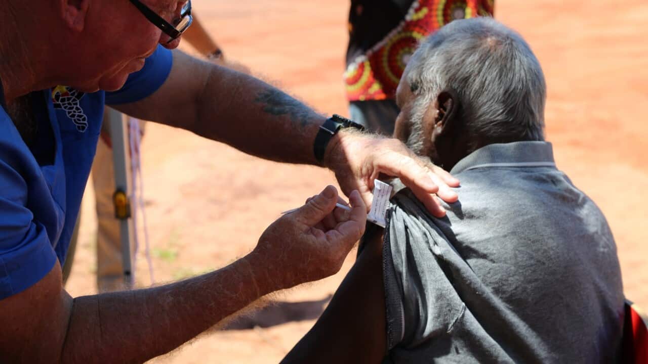A man receives a coronavirus vaccine in the remote Aboriginal community of Beagle Bay, WA