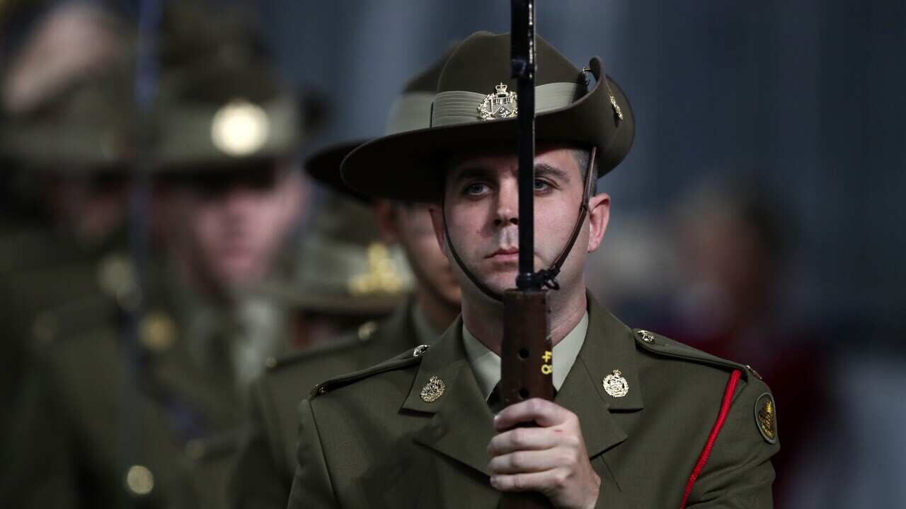 Participants during the Anzac Day ceremony before the Round 6 AFL match between the Fremantle Dockers and the Western Bulldogs at Optus Stadium in Perth, Saturday, April 27, 2019. (AAP Image/Gary Day) NO ARCHIVING, EDITORIAL USE ONLY