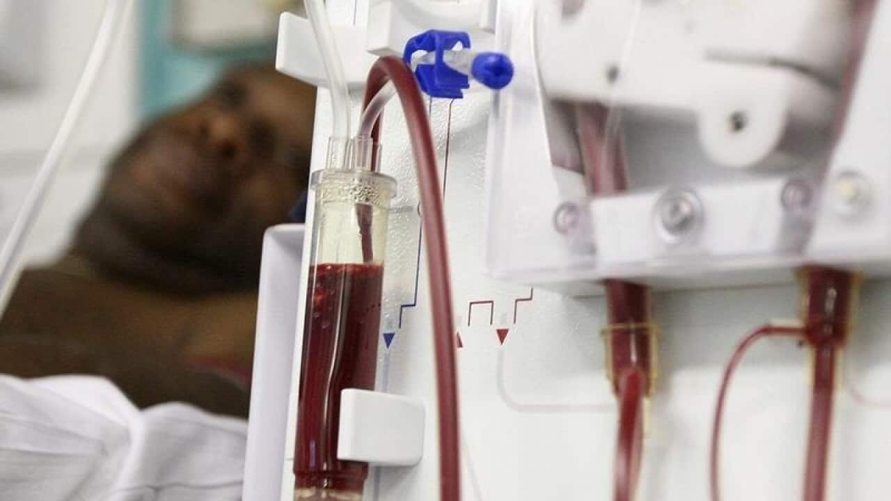 A patient receiving treatment on a dialysis machine