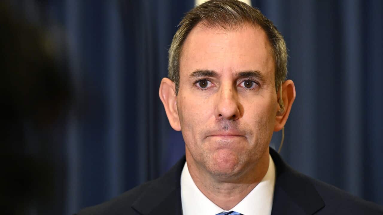 A middle-aged white man with short black and grey hair. He's frowning.