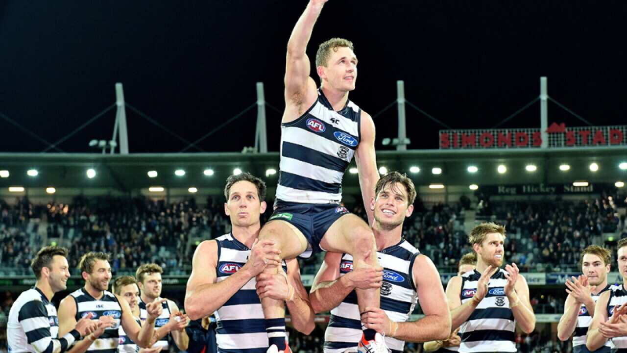 Joel Selwood of the Cats is carried off the ground by team-mates