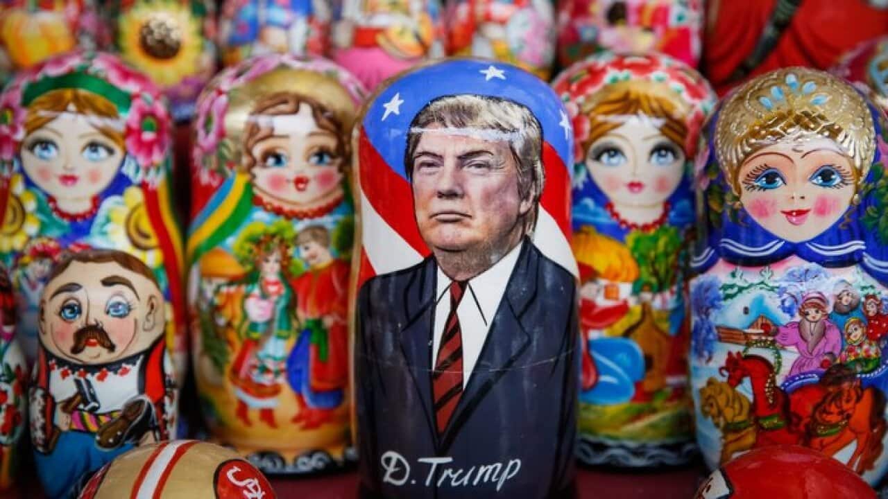 A matryoshka doll with the face of US President-elect Donald Trump surrounded by other matryoshkas