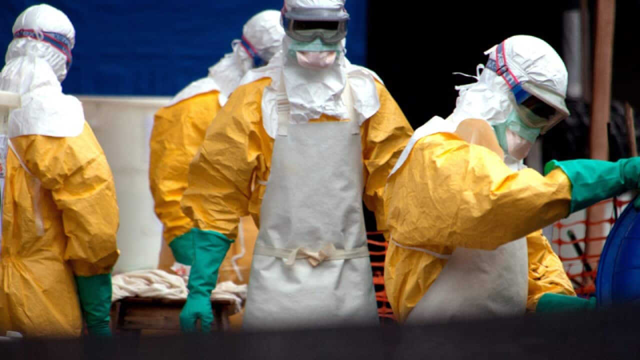 Medical workers in protective suits.