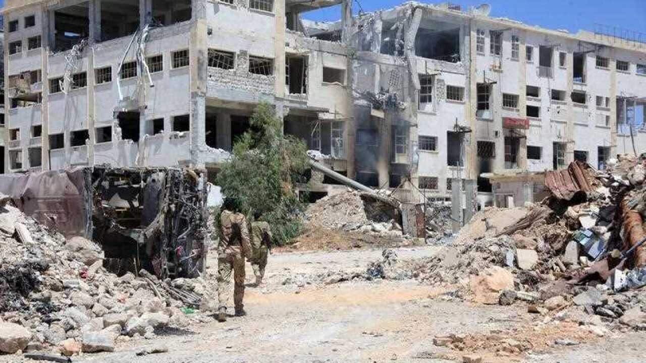 Syrian government soldiers patrolling in al-Layramoun and Bani Zein neighborhoods after recapturing from rebels in the northern province of Aleppo, Syria.