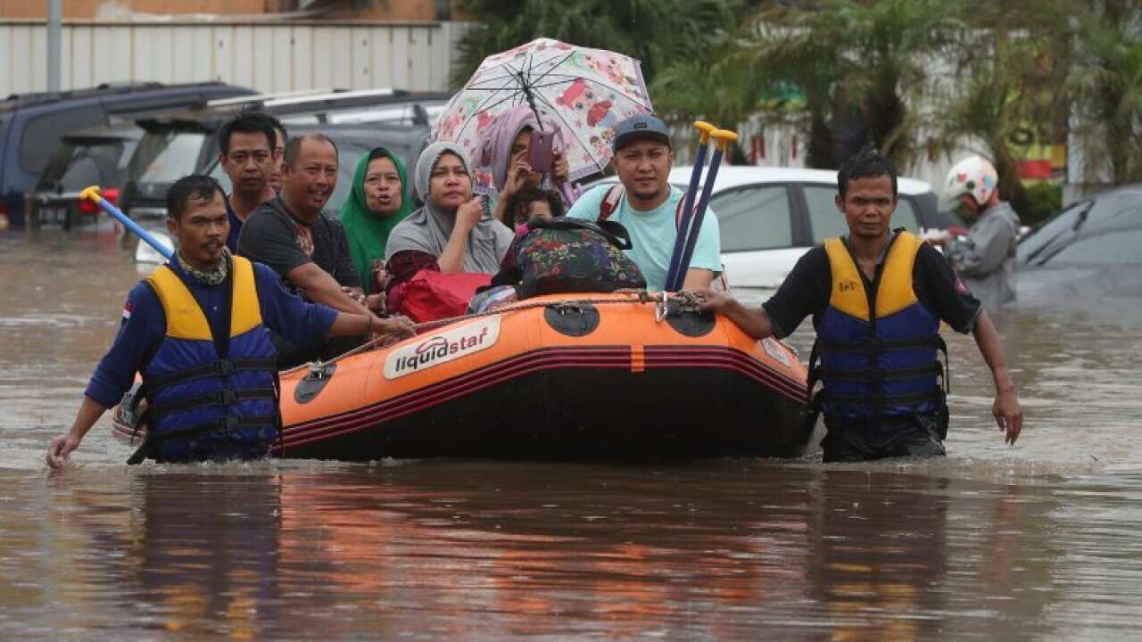 A rescue team evacuates residents from their flooded house at Jatibening on the outskirts of Jakarta, Indonesia, 01Jan 2020.