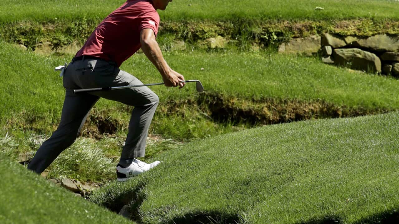 Adam Scott crosses the creek on the 13th hole