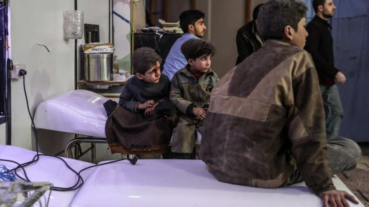 Injured children with their brothers at a hospital in Syria