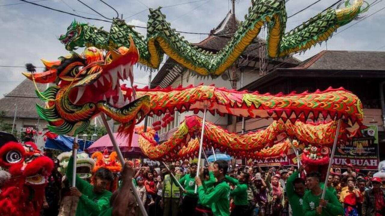 Men perform a dragon dance called Liong ahead of the upcoming Chinese Lunar New Year during the Grebeg Suro ceremony in Solo, Central Java.