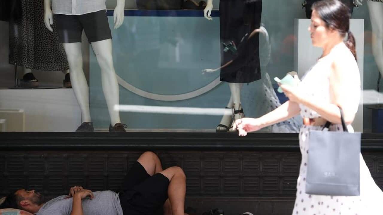 A man sleeping outside the Queen Victoria Building in Sydney,