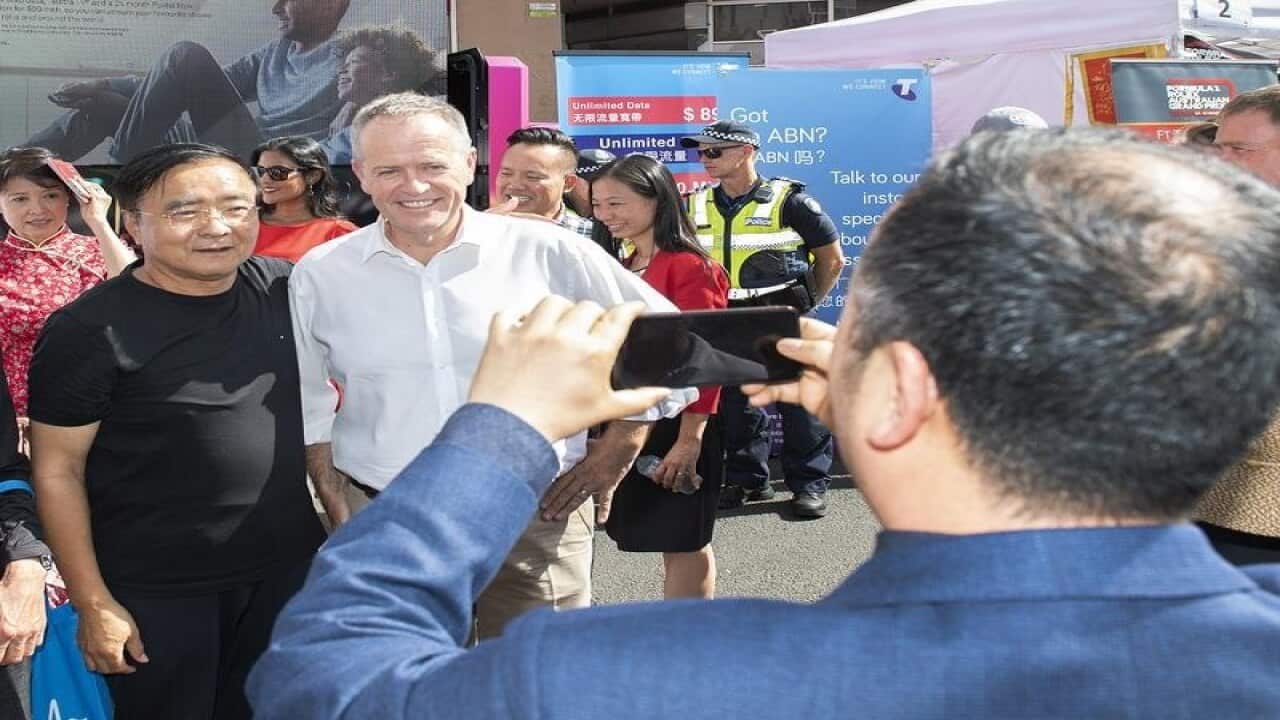 Bill Shorten poses for photos at the Chinese New Year ceremony.