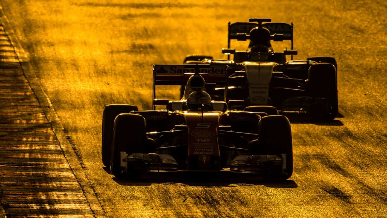 Sebastian Vettel (GER) Ferrari leads Nico Rosberg (GER) Mercedes