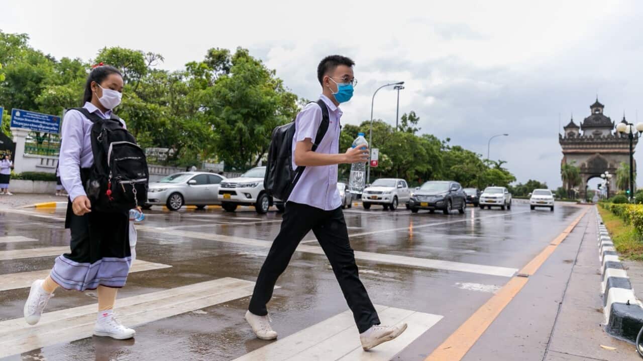 Students wearing masks cross a street after school in Vientiane, Laos, May 19, 2020 (Kaikeo Saiyasane - Xinhua via Getty).jpg