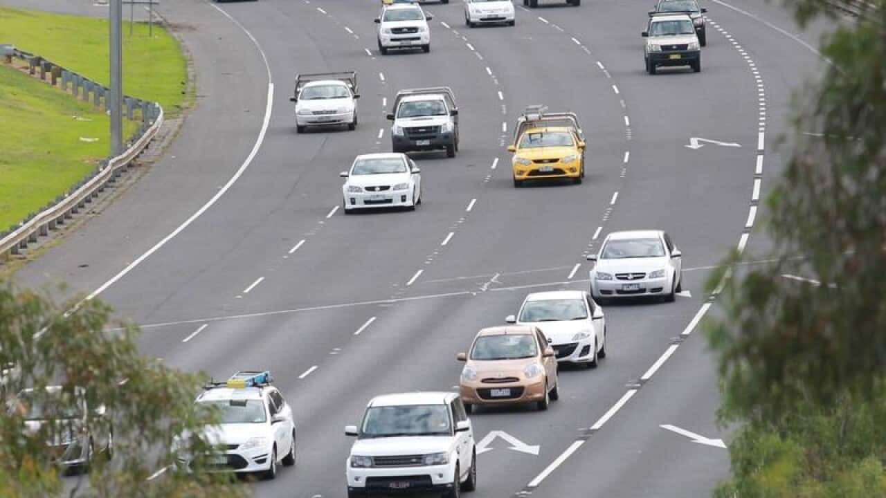 Cars drive on the Eastern Freeway.