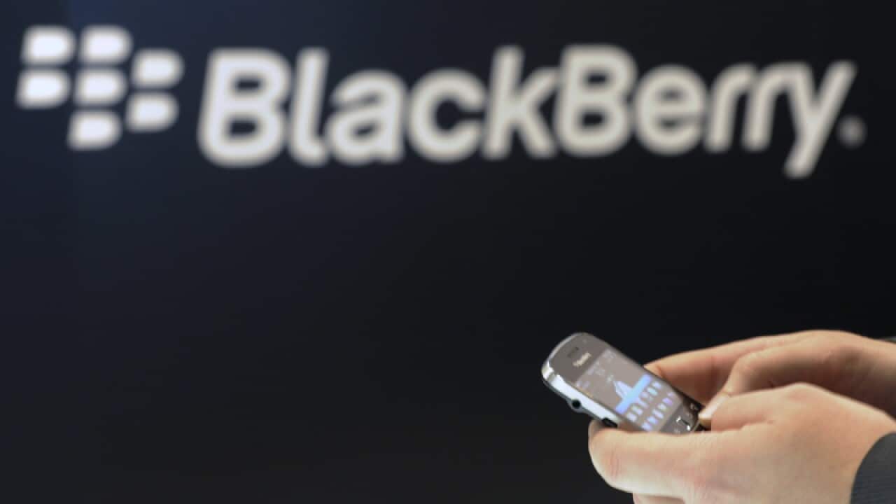 A Blackberry employee holds a mobile phone