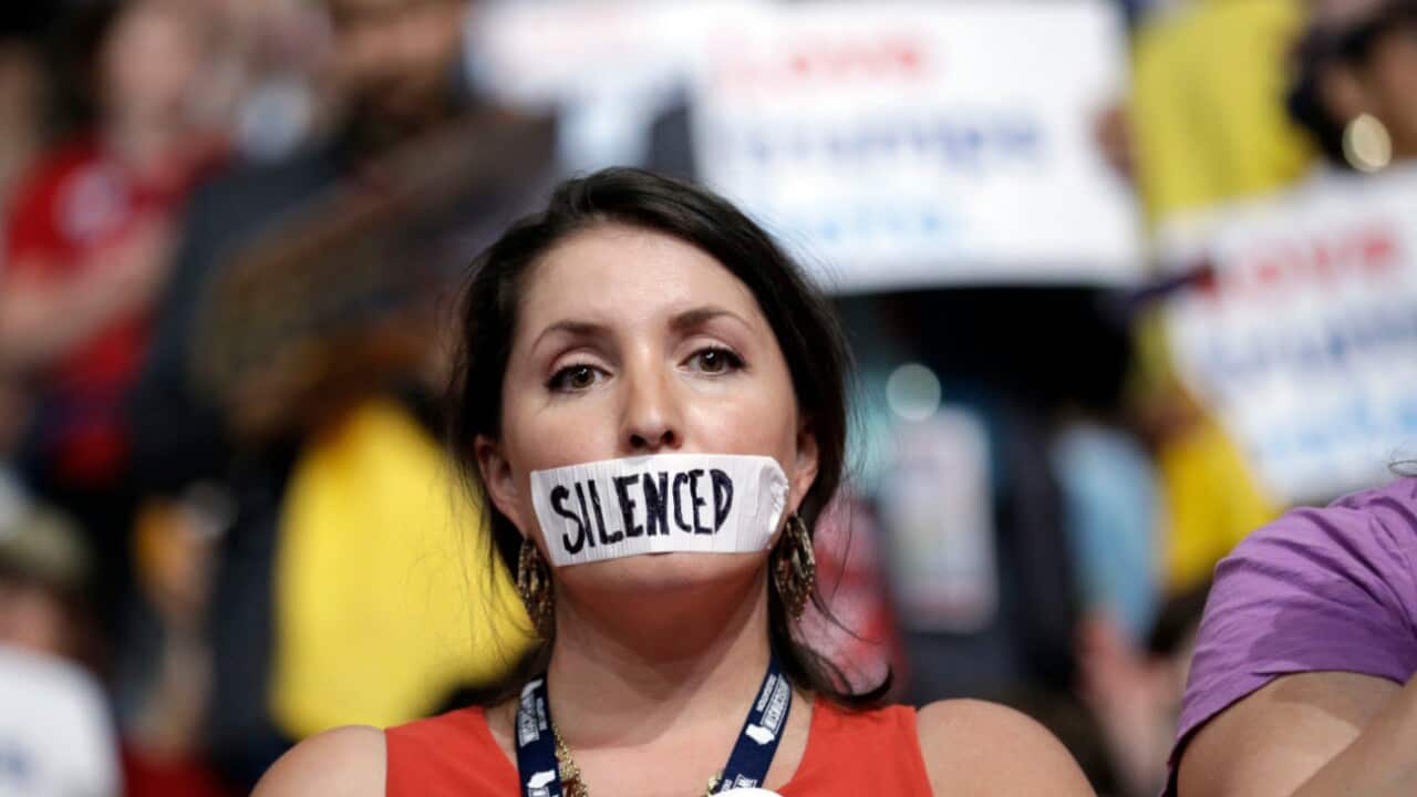 Wisconsin delegate Angie Aker wears tape covering her mouth during the first day of the Democratic National Convention in Philadelphia