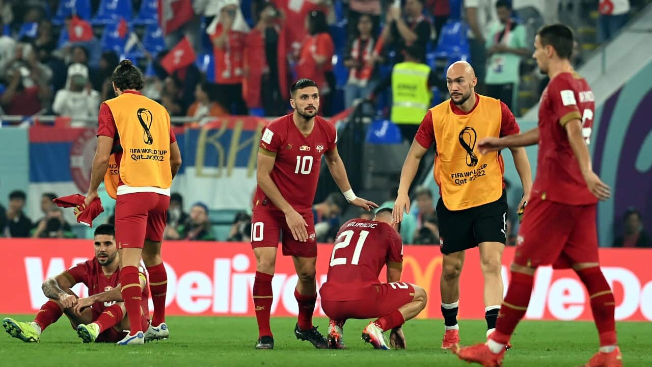 Dusan Tadic of Serbia (C) and teammates react after the FIFA World Cup 2022 defeat in the hands of Switzerland