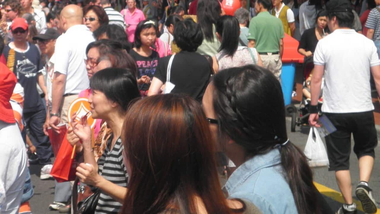 Mostly Asian people in an outdoor area