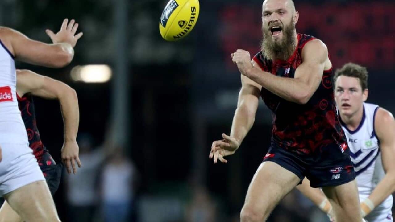 Max Gawn of the Demons passes the ball during Round 16.