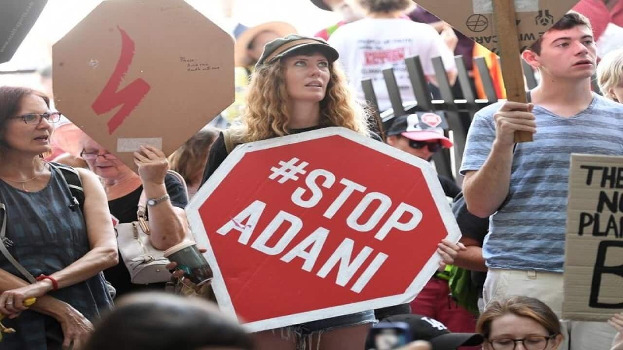 Anti Adani coal mine protesters engage in a sit-in protest in Brisbane