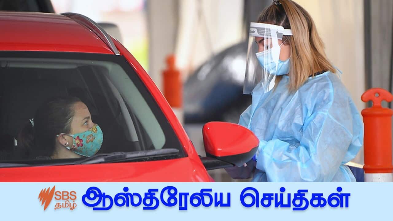Healthcare workers are seen at drive through testing facility at Springers Leisure Centre in Cheltenham, Melbourne, Thursday, December 31, 2020.