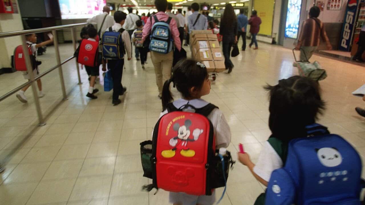Children of Hong Kong SAR permanent residents living in Shenzhen cross the Shenzhen border checking point on their way to schools in the SAR.
