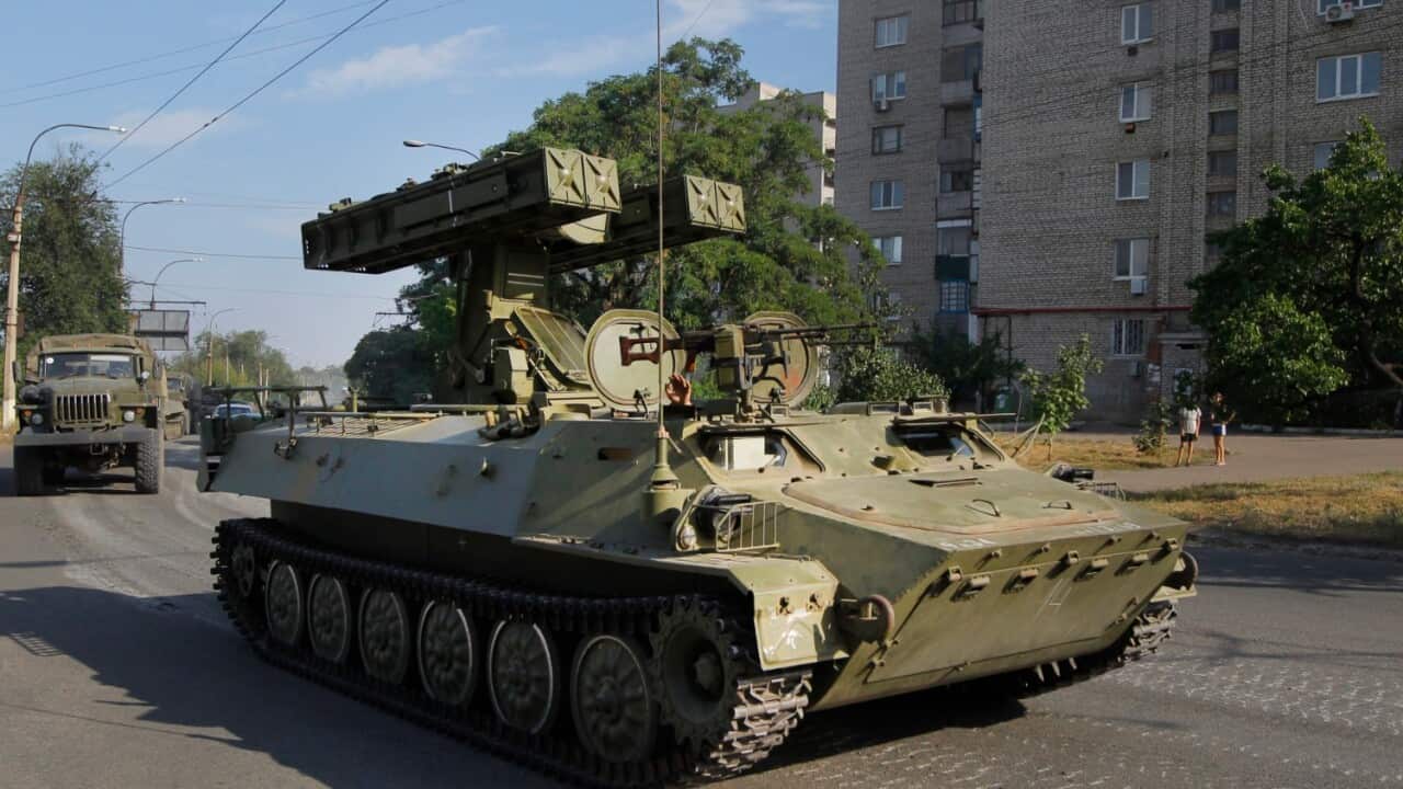 In this is Sunday, Aug. 17, 2014 file photo, a pro-Russian missile launcher drives in the town of Krasnodon.