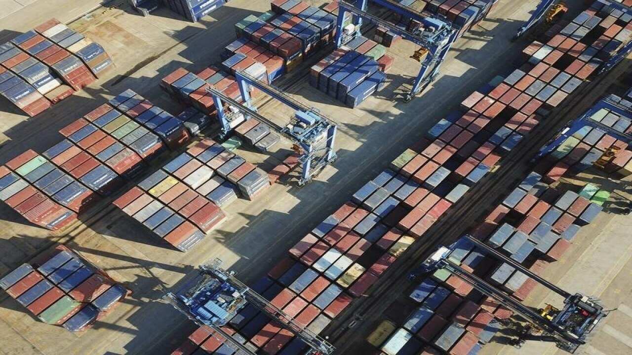 Stacks of containers to be shipped abroad are seen at a port.