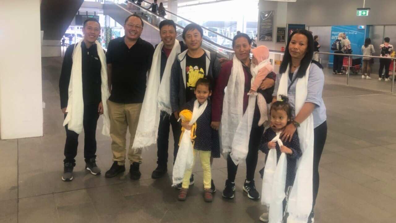 Jigme Dorjee (second from left) with Tibetan new arrivals from India at Sydney International Airport.