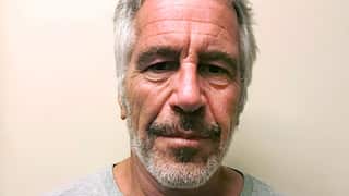 A man with short grey hair in a light t-shirt