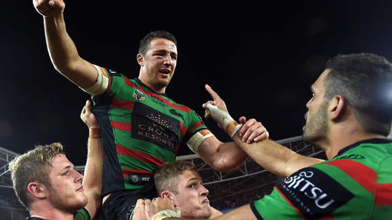 Rabbitohs' Sam Burgess is lifted up by his brothers and teammates following their win during the 2014 NRL Grand Final match between the South Sydney Rabbitohs and the Canterbury-Bankstown Bulldogs at ANZ Stadium in Sydney