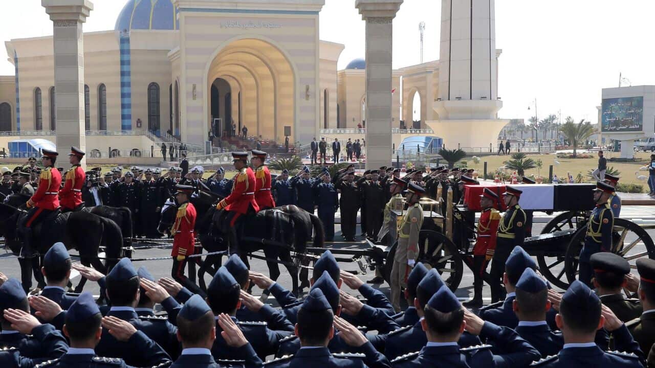 Officers salute as the horse-drawn carriage transporting the flag-draped coffin former Egyptian President Hosni Mubarak passes by during the funeral at Mosheer Tantawy mosque, in Cairo, Egypt, 26 February 2020. Mubarak died on 25 February 2020 aged 91. Mu