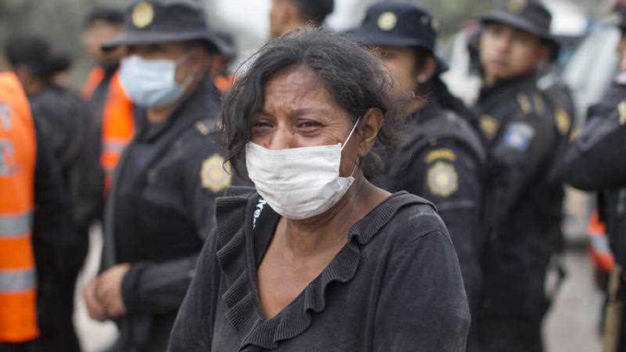 A resident cries after she was safely evacuated from her home near the Volcan de Fuego, or "Volcano of Fire," in Escuintla, Guatemala, Monday, June 4, 2018.