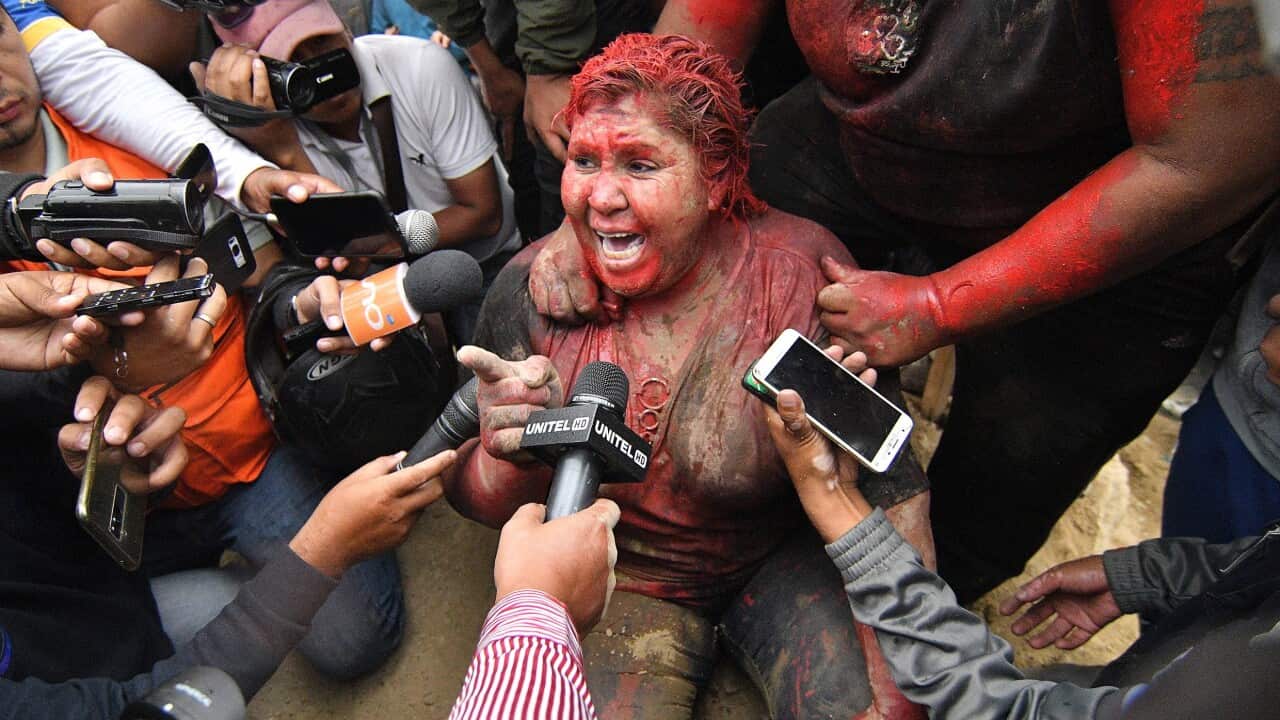 Mayor of Vinto, Patricia Arce, speaks to the media after being attacked in the street by a crowd that sprayed her with reddish paint and cut her hair.