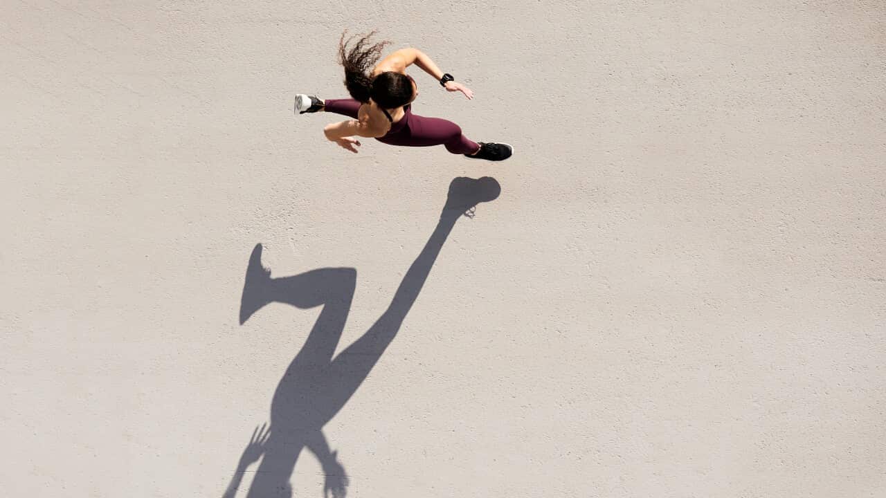 Sprinter seen from above with shadow and copy space.