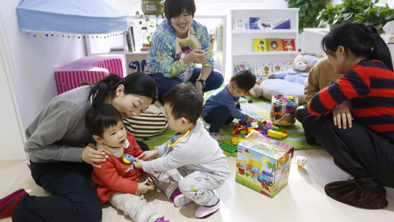 Chinese parents and their children playing together at the Magic International Daycare, a high end child care center in Beijing, China