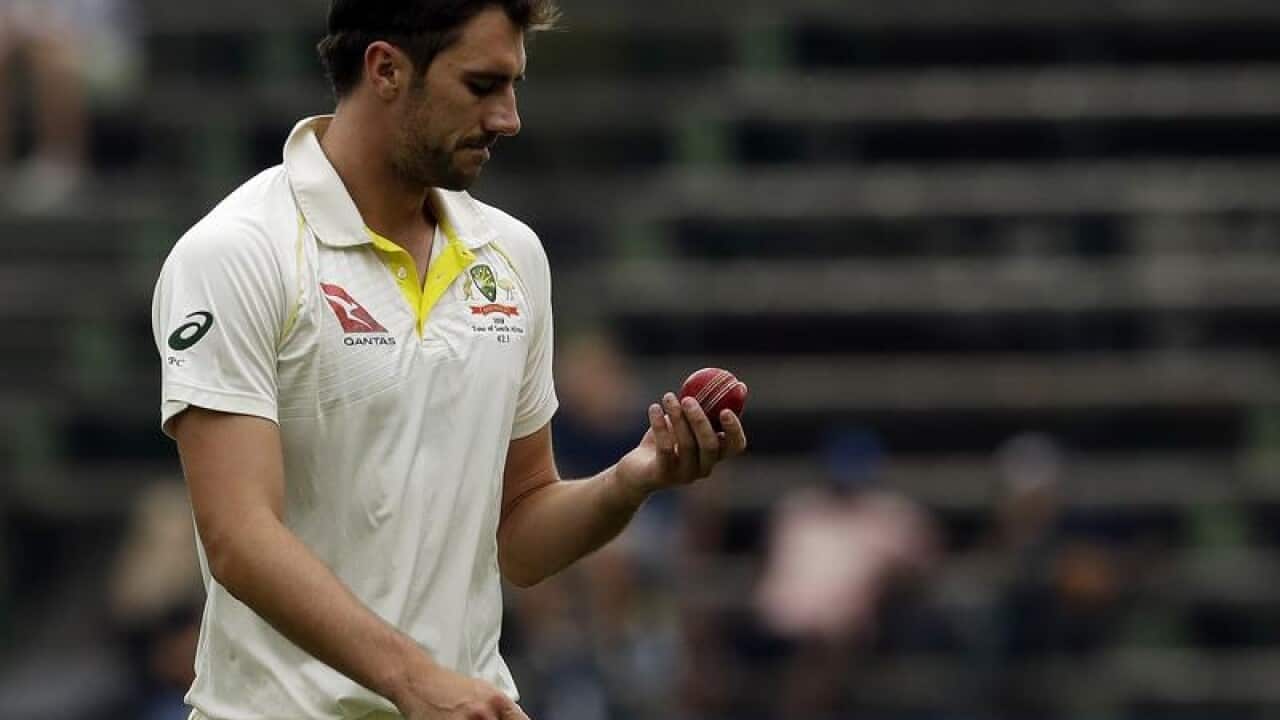 Australia's batsman Pat Cummins prepares to bowl.