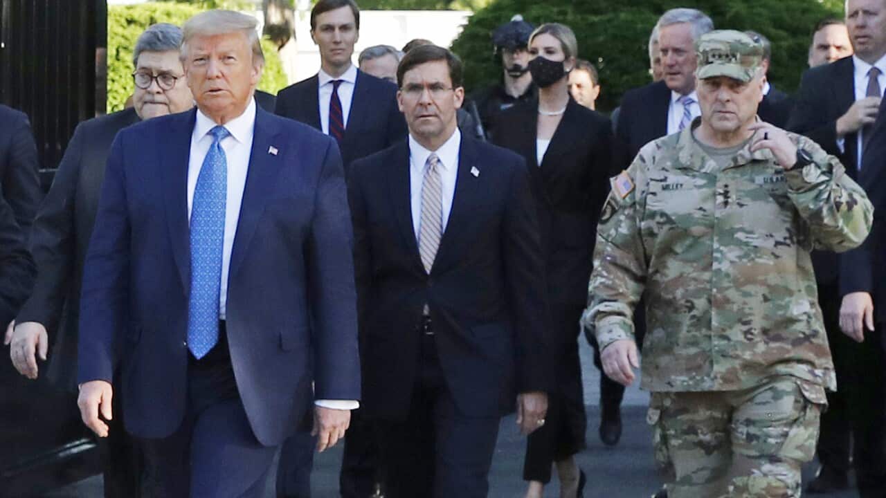 President Donald Trump (L) departs the White House with top US military officer Mark Milley (R) to visit outside St. John's Church.