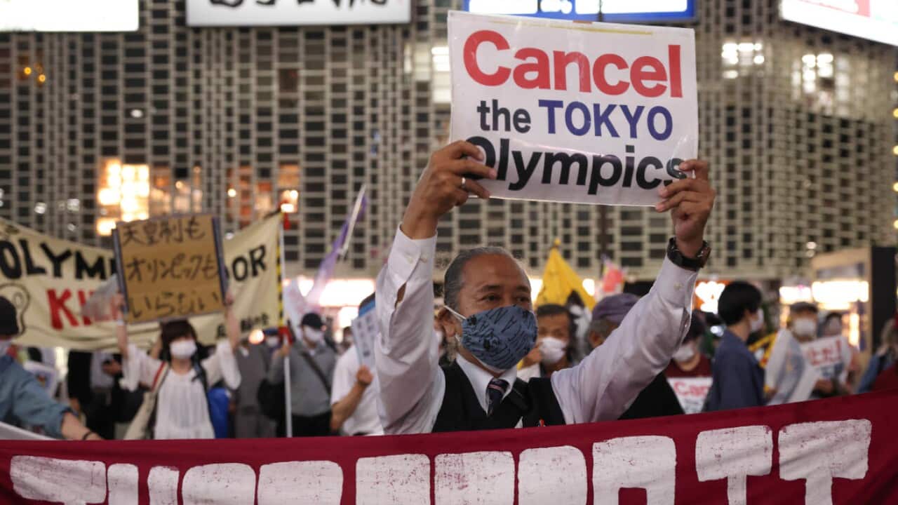 Protesters hold up banners during an anti-Olympics rally in Tokyo's Ginza district.