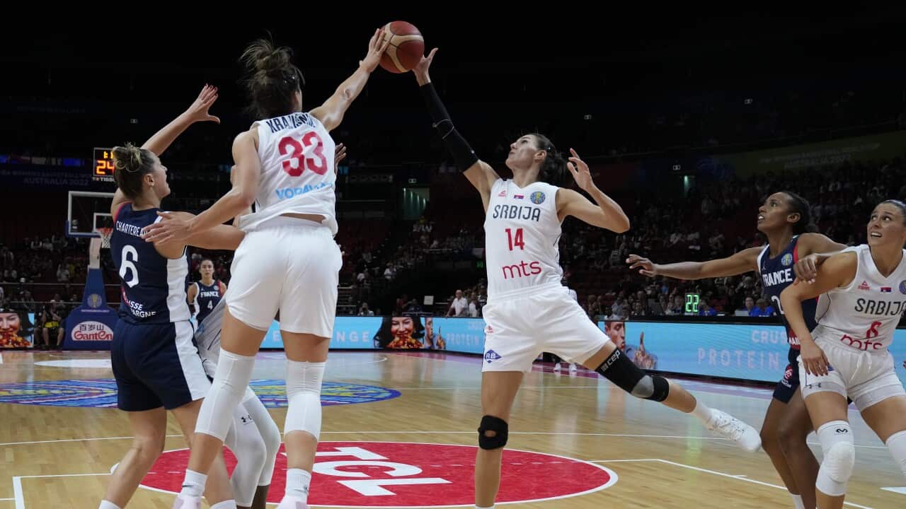 Serbia's Tina Krajisnik and teammates Dragana Stankovic and Sasa Cadjo battle for the ball with France's Alexia Chartereau, during their game at the women's Basketball World Cup in Sydney