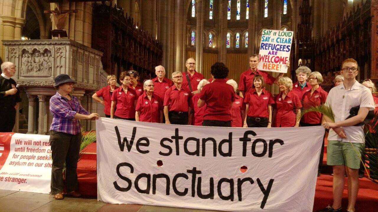 Anglican Dean of Brisbane, Reverend Dr Peter Catt, holds a Palm Sunday 'Rally for Refugees'.