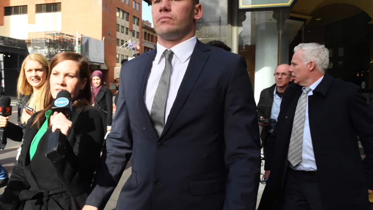 Shaun Kenny-Dowall (C) leaves the Downing Centre Courts in Sydney
