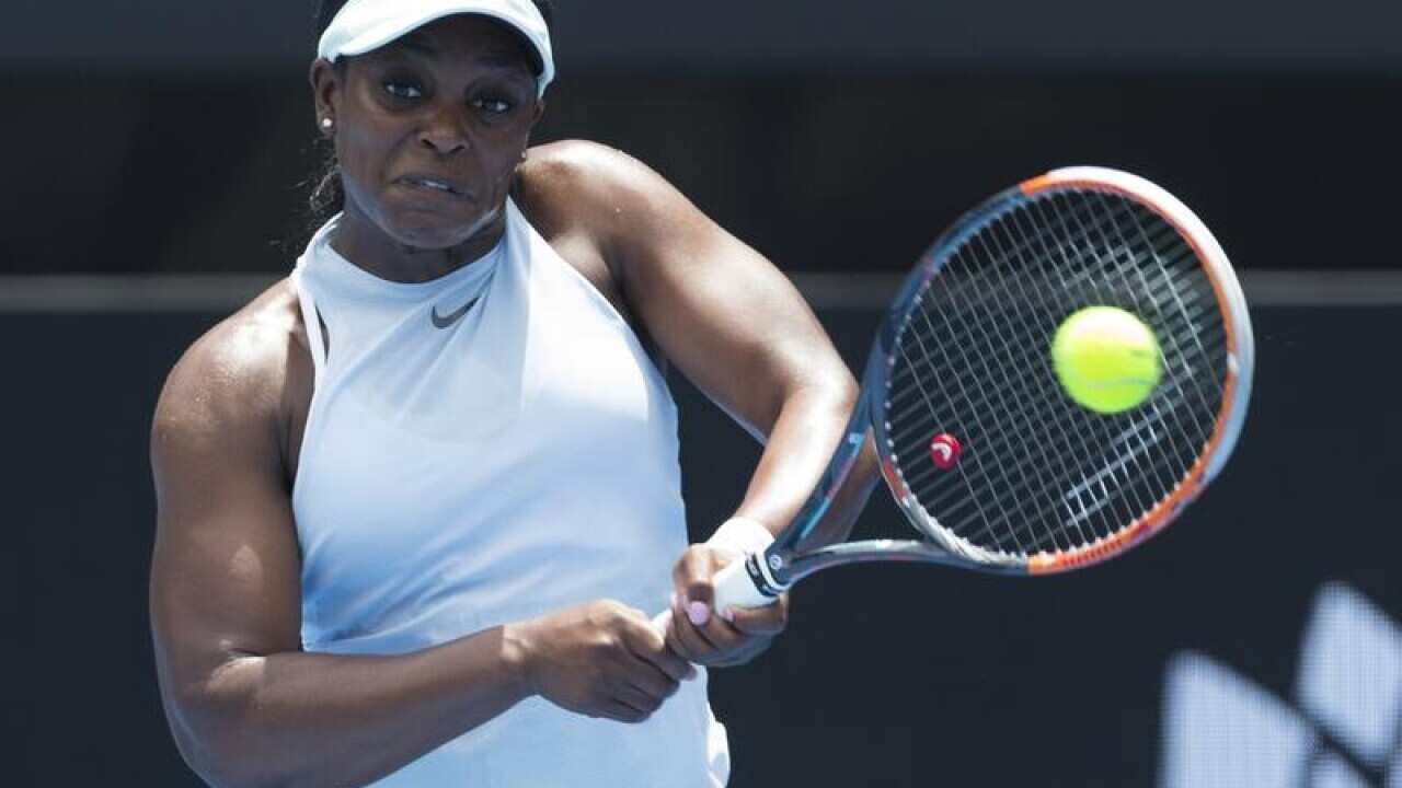Sloane Stephens of the USA returns serve against Camila Giorgi.