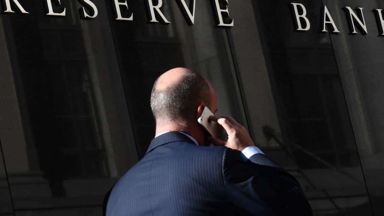 This is a file image of a pedestrian walking past the RBA in Sydney.