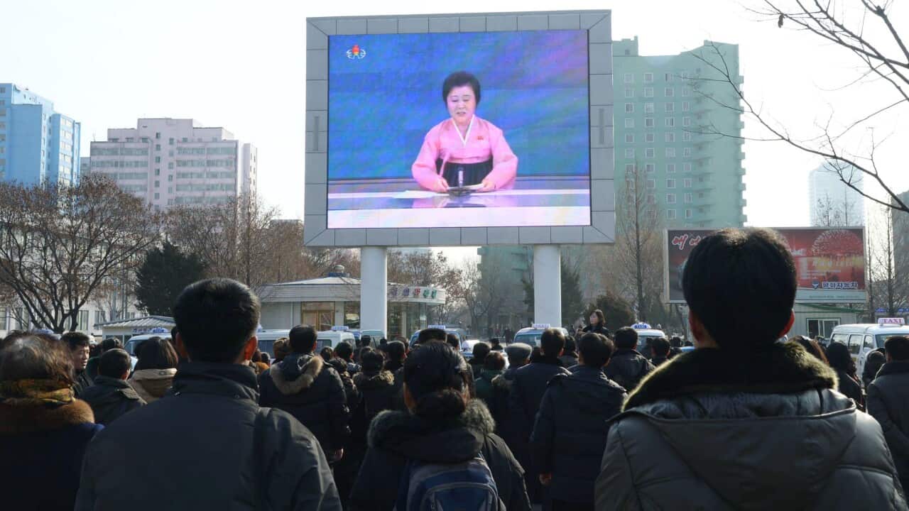 North Korean citizens watch a broadcast by the Korean Central Television saying the country has successfully conducted its first hydrogen bomb test, on a huge screen outside Pyongyang's main railway station on Jan. 6, 2016.