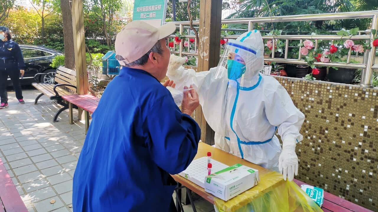Staff from the Zhejiang Quzhou Medical Team conduct COVID-19 tests for residents of a closed community in Shanghai.