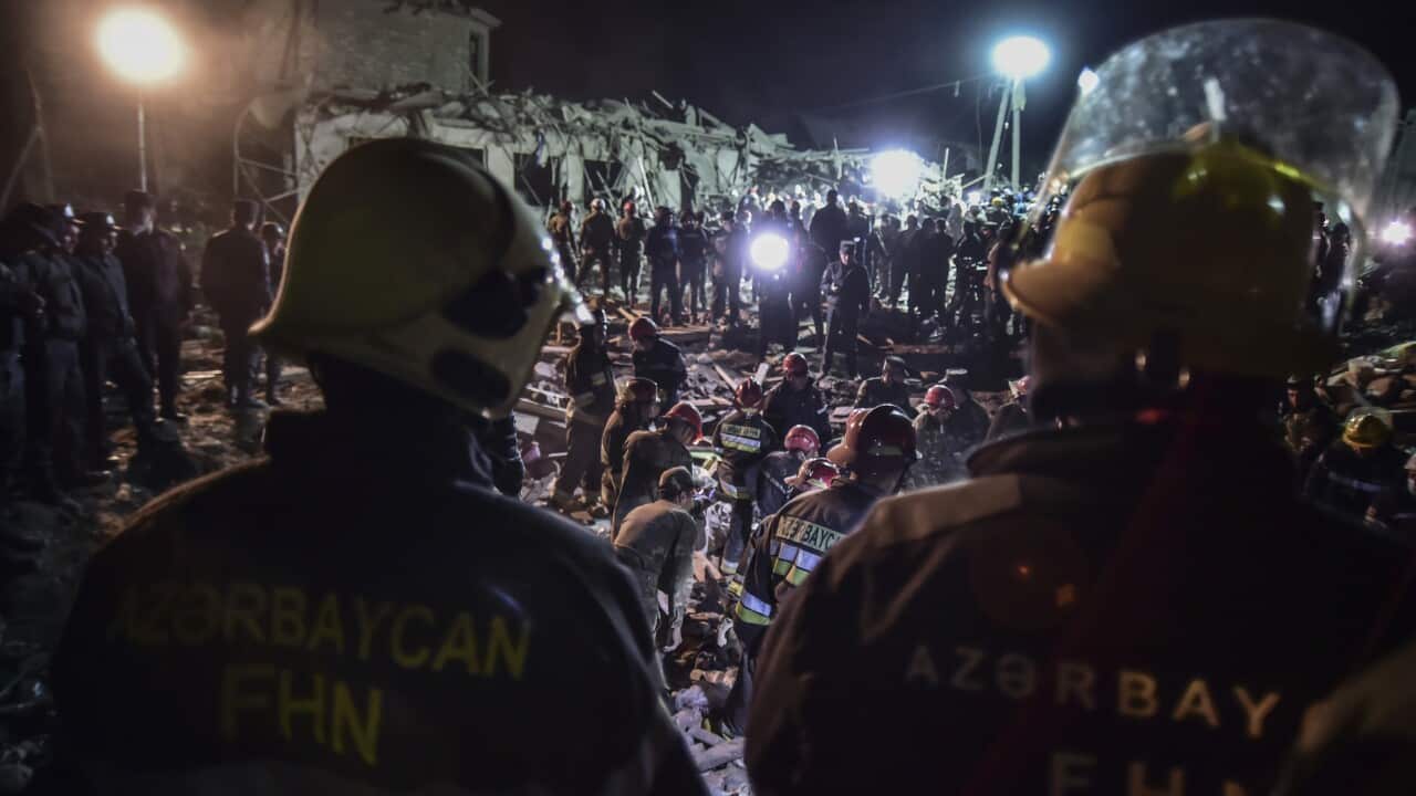 Azerbaijani soldiers try to save survivors from destroyed houses in a residential area in Ganja, Azerbaijan's second largest city, near the border with Armenia.