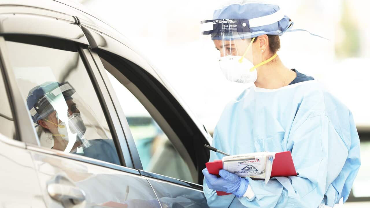 Healthcare workers administer COVID-19 tests at the Bondi Beach drive-through testing center.