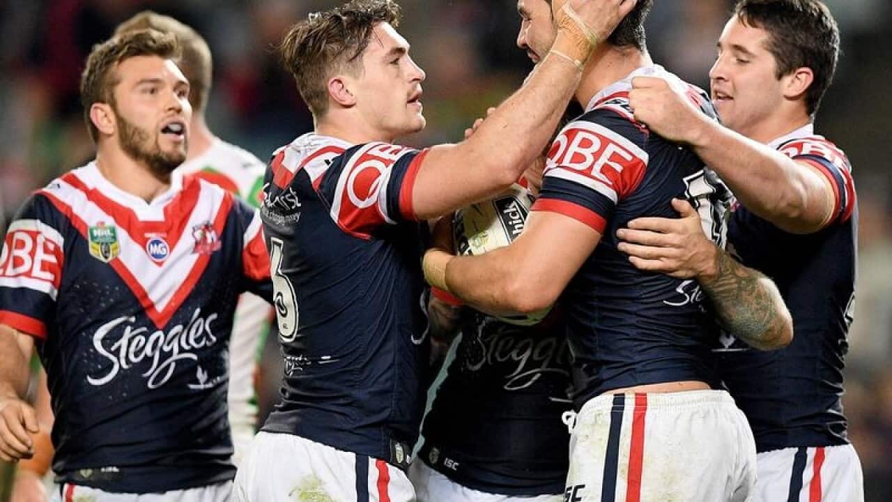 Aidan Guerra of the Roosters (2R) celebrates after scoring a try