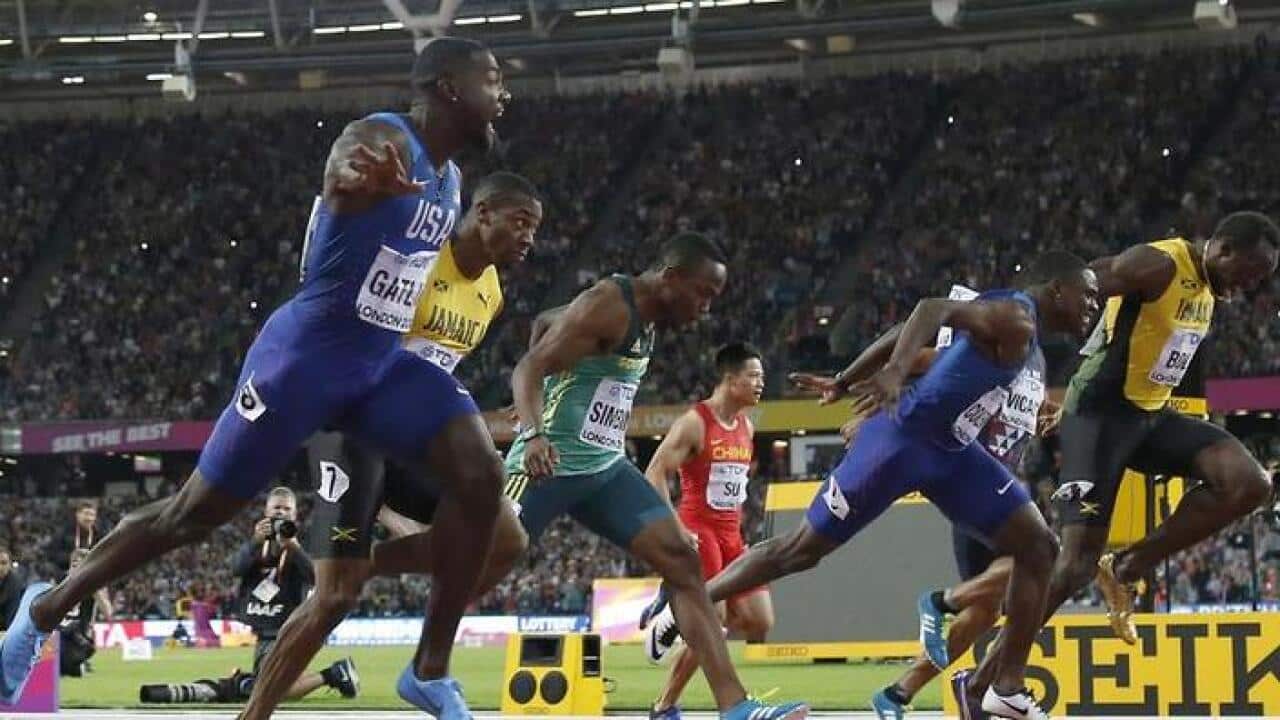 Justin Gatlin, left, crosses ahead of Christian Coleman, second right, and Usain Bolt, right.